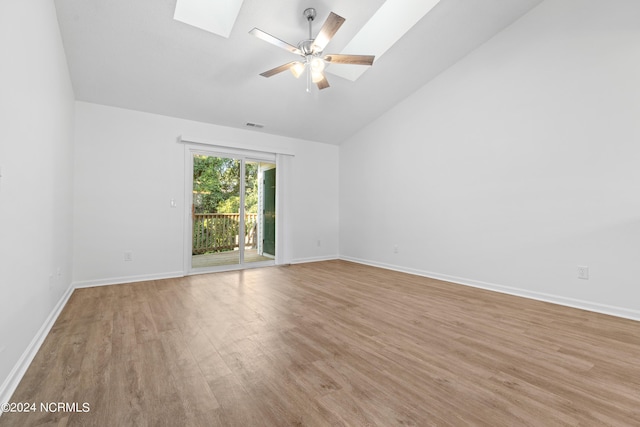 unfurnished room featuring light hardwood / wood-style flooring, lofted ceiling with skylight, and ceiling fan