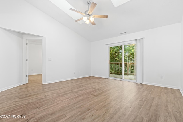 unfurnished room featuring a skylight, high vaulted ceiling, ceiling fan, and light wood-type flooring