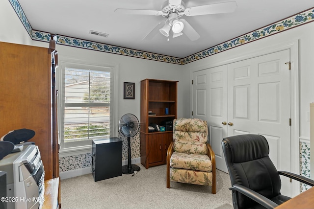 office with light carpet and ceiling fan