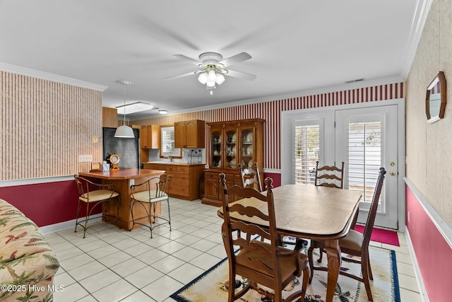 dining area with ornamental molding, light tile patterned floors, and ceiling fan