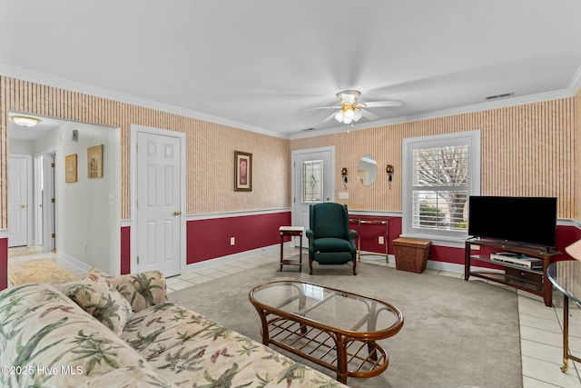 living room featuring ornamental molding, light tile patterned flooring, and ceiling fan