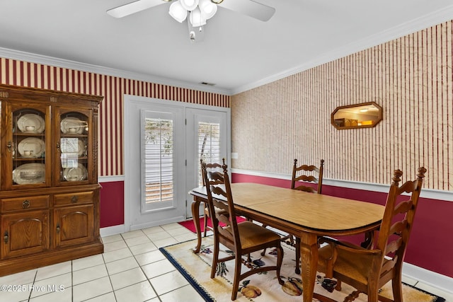 tiled dining space with crown molding and ceiling fan