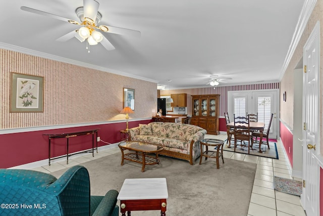 living room with crown molding, light tile patterned floors, and ceiling fan