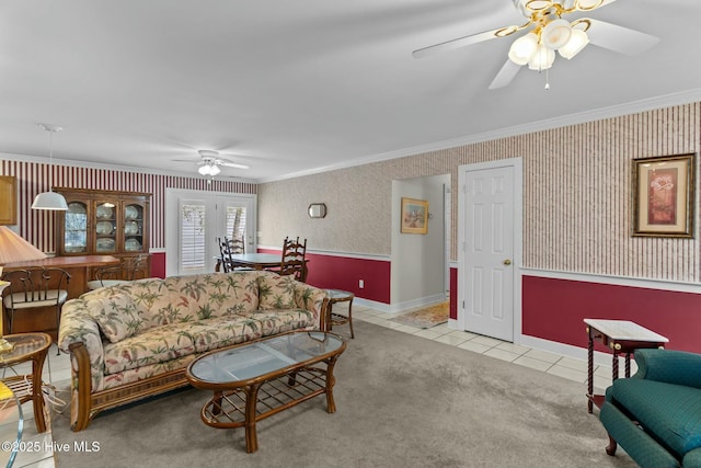 tiled living room with ceiling fan and ornamental molding