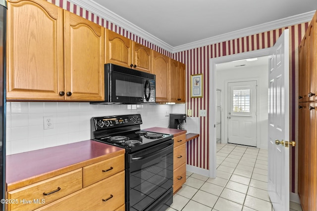 kitchen with light tile patterned flooring, ornamental molding, tasteful backsplash, and black appliances