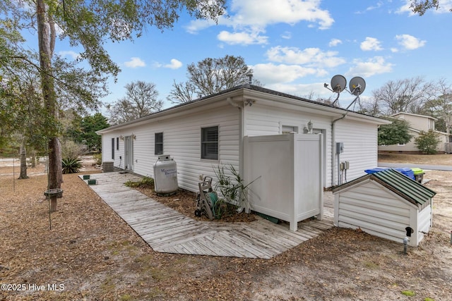 rear view of property featuring a deck