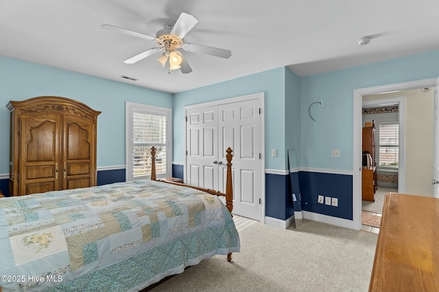 bedroom with light colored carpet, a closet, and ceiling fan