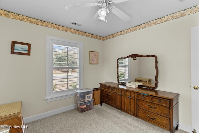 interior space with light carpet and ceiling fan