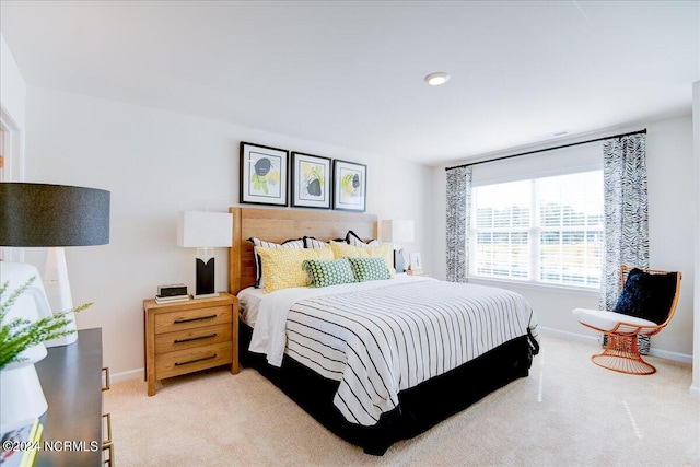 bedroom featuring light carpet