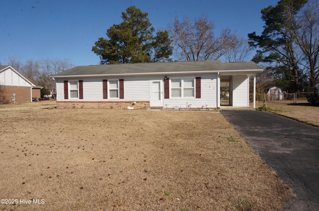 single story home featuring a carport and a front yard