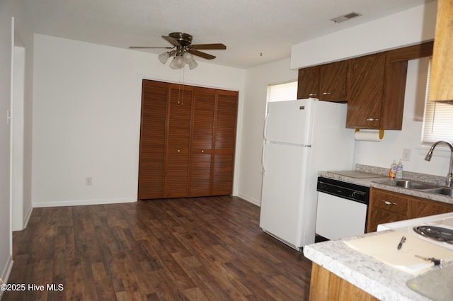 kitchen featuring ceiling fan, white appliances, dark hardwood / wood-style flooring, and sink