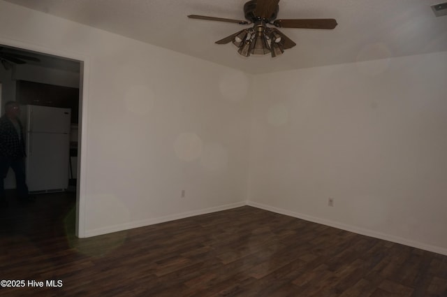 empty room with dark wood-type flooring and ceiling fan