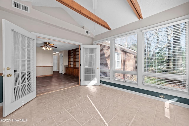 interior space featuring vaulted ceiling with beams, light tile patterned floors, a textured ceiling, and ceiling fan