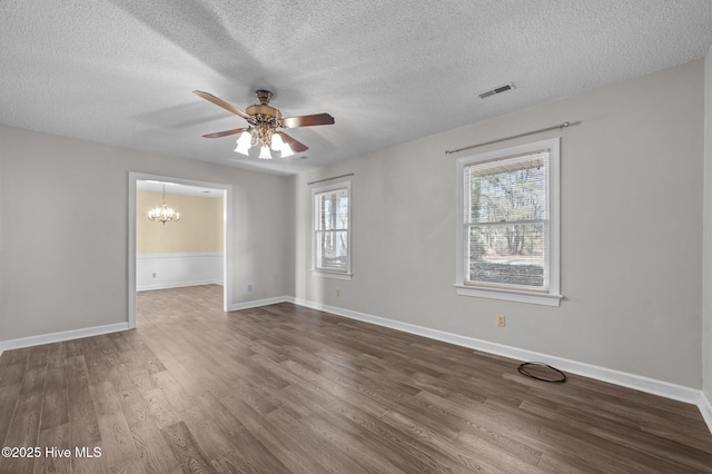 unfurnished room with dark hardwood / wood-style floors, ceiling fan with notable chandelier, and a textured ceiling