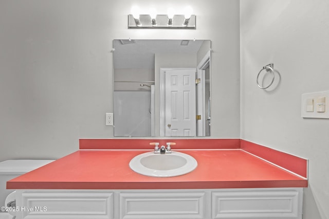 bathroom with vanity and toilet