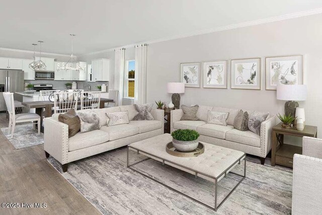 253 Hawks Run Dr Unit 4060, Carolina Shores, NC 28467 - living room featuring light wood-style floors, crown molding, and a chandelier