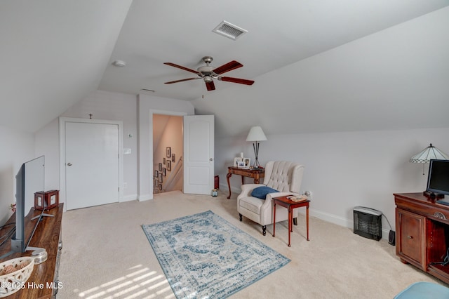 living area with vaulted ceiling, light carpet, and ceiling fan