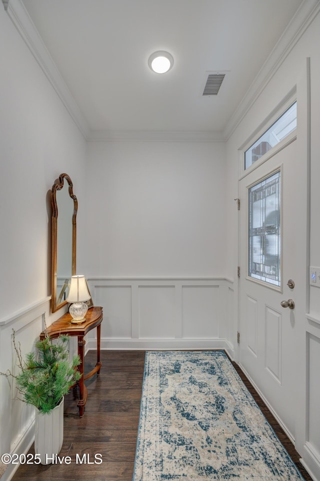 foyer entrance featuring crown molding and dark hardwood / wood-style floors