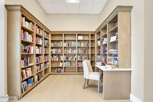 tiled home office with a drop ceiling