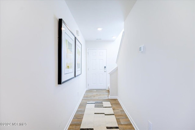 hall with hardwood / wood-style flooring