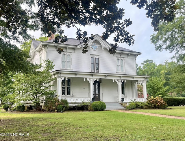 italianate-style house with covered porch and a front lawn