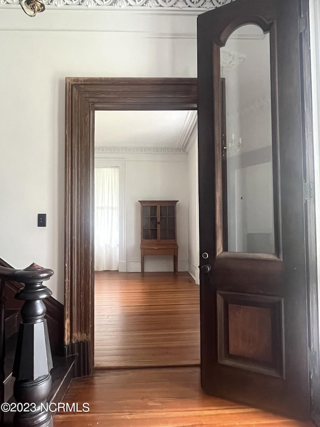 interior space with wood-type flooring and ornamental molding