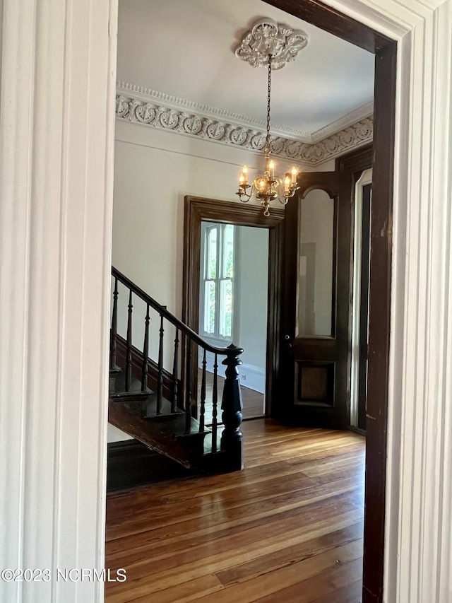 entrance foyer with wood-type flooring and an inviting chandelier