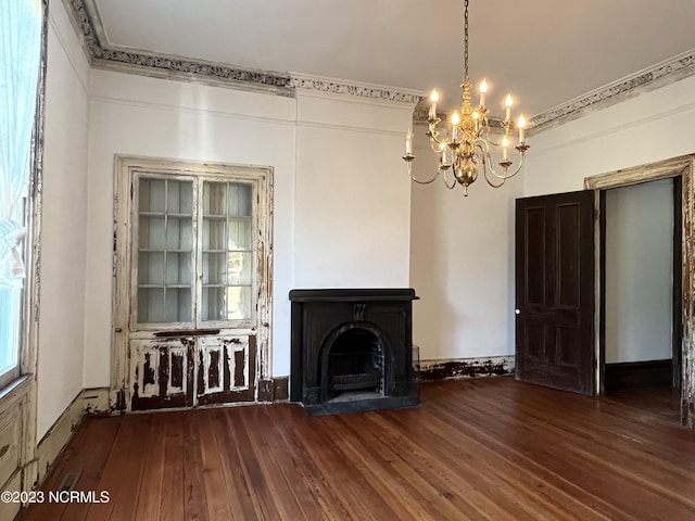 unfurnished living room with an inviting chandelier and wood-type flooring