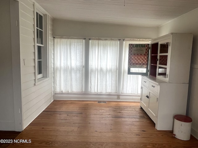 unfurnished dining area with dark hardwood / wood-style flooring