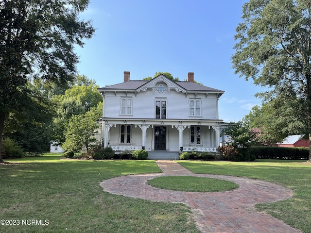 italianate house with a porch and a front lawn