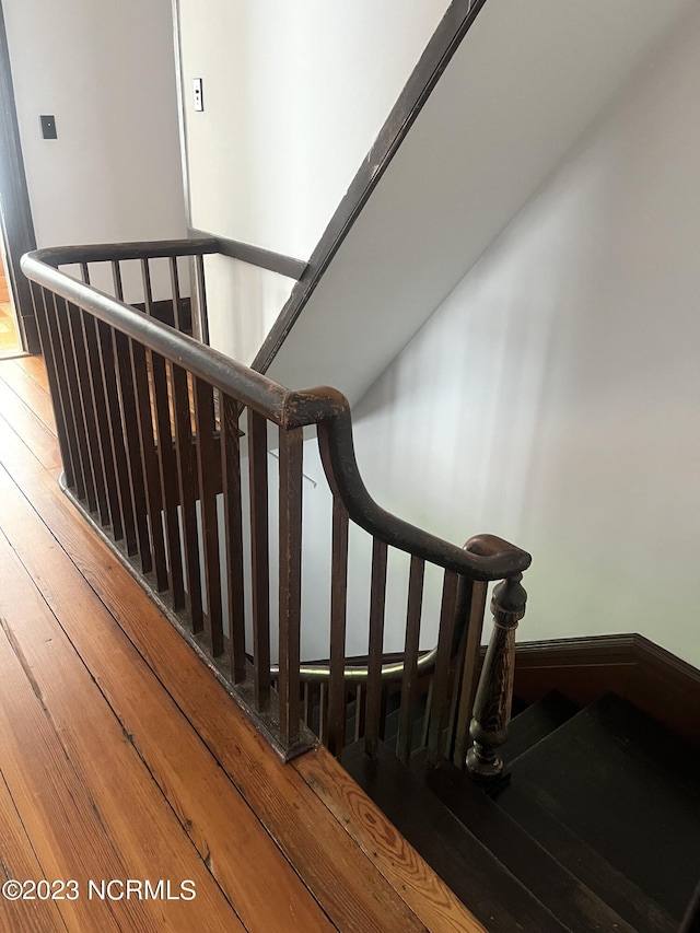 stairs featuring wood-type flooring