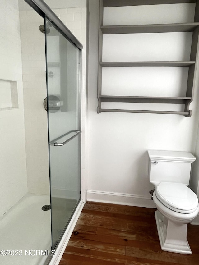 bathroom with walk in shower, wood-type flooring, and toilet