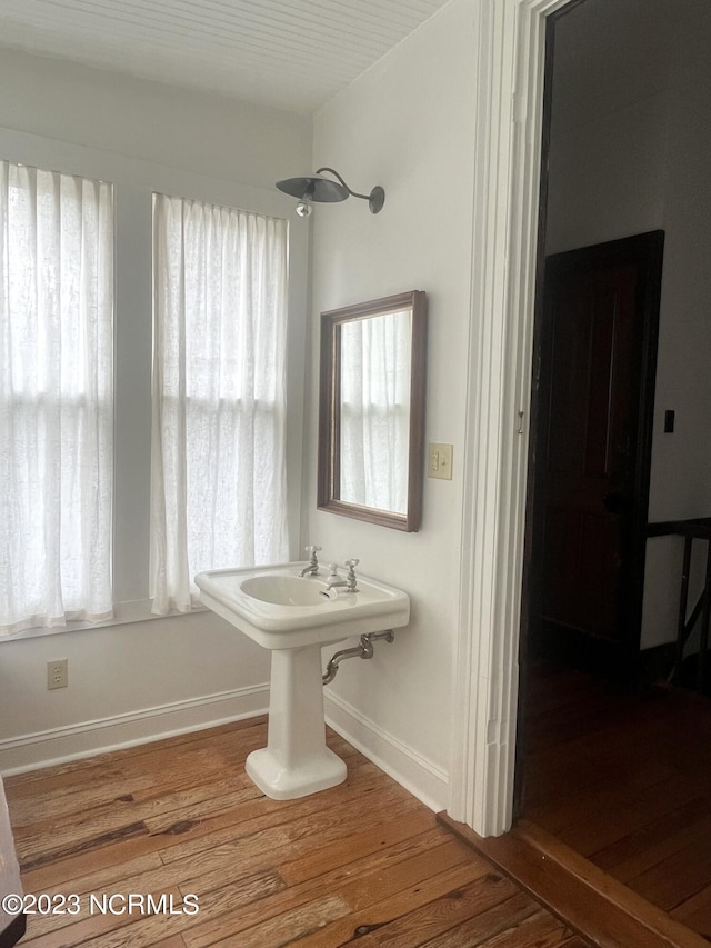 bathroom featuring wood-type flooring and a shower