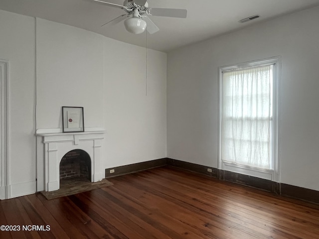 unfurnished living room with ceiling fan and dark hardwood / wood-style flooring