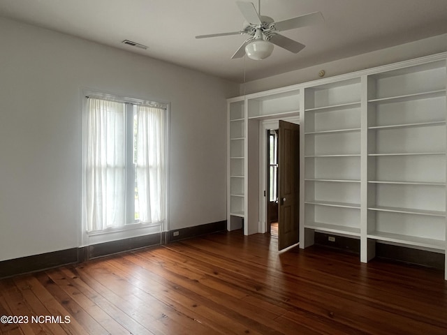 unfurnished bedroom featuring dark hardwood / wood-style floors and ceiling fan