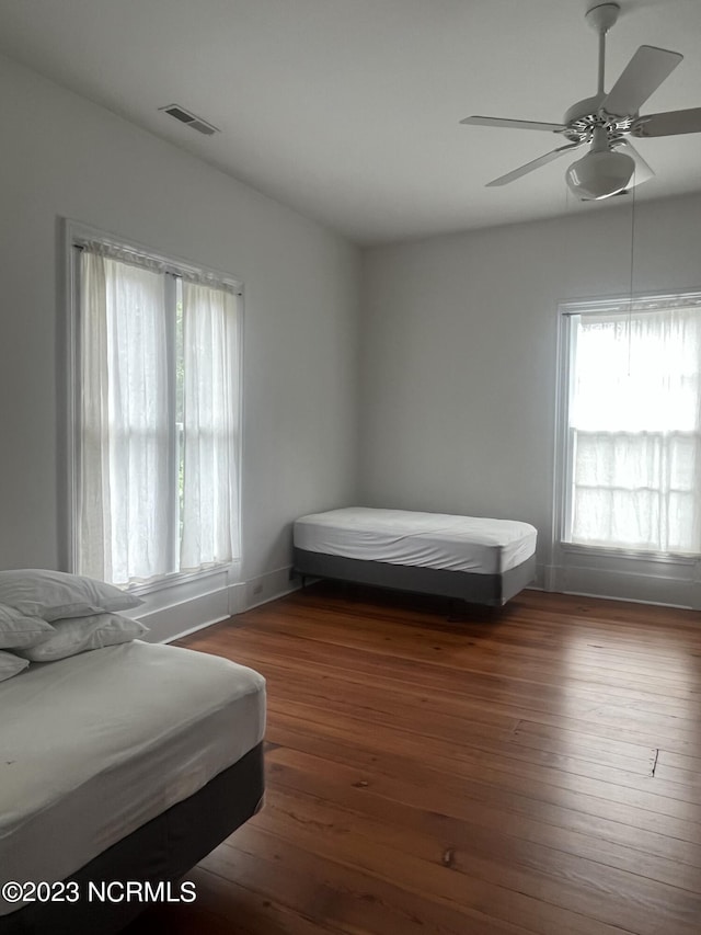 bedroom featuring hardwood / wood-style flooring, vaulted ceiling, and ceiling fan