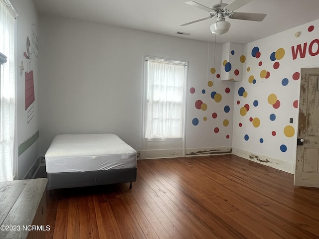 bedroom with dark wood-type flooring and ceiling fan