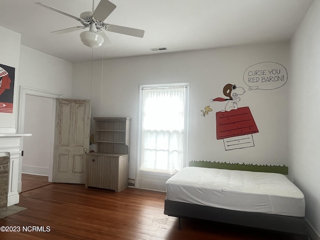 bedroom featuring ceiling fan, radiator, and dark hardwood / wood-style flooring