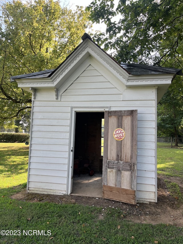 view of outbuilding with a yard