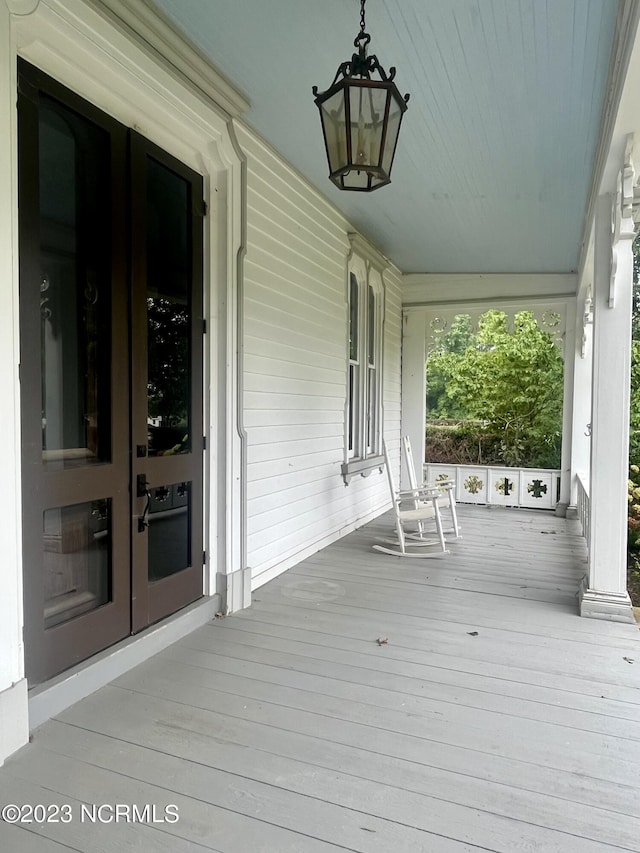 wooden deck featuring french doors and a porch