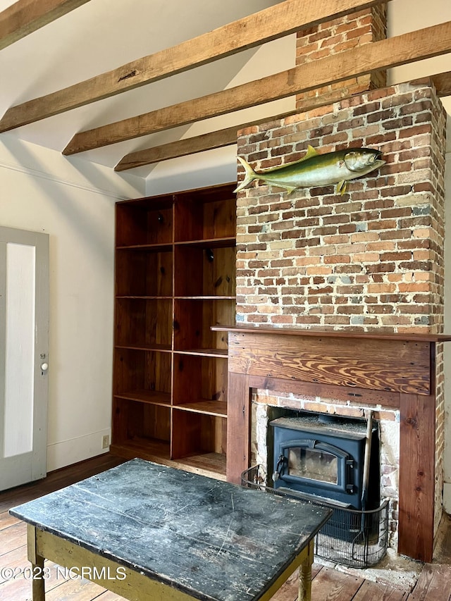 unfurnished living room with hardwood / wood-style floors and beam ceiling