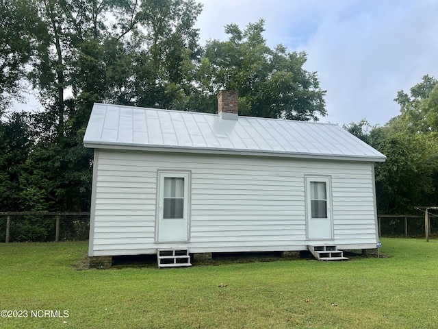 back of property featuring a yard