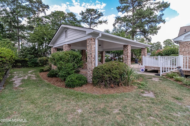 view of home's exterior with a wooden deck and a lawn