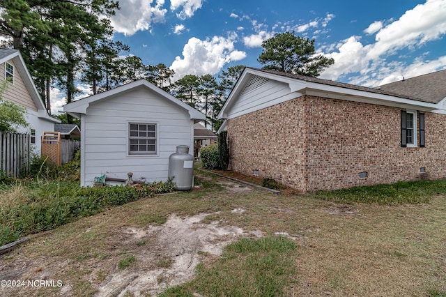 rear view of house featuring a lawn