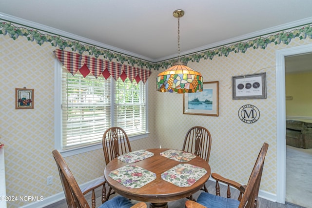 dining space with crown molding and wood-type flooring