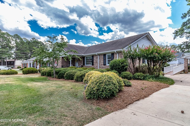 ranch-style house with a front lawn