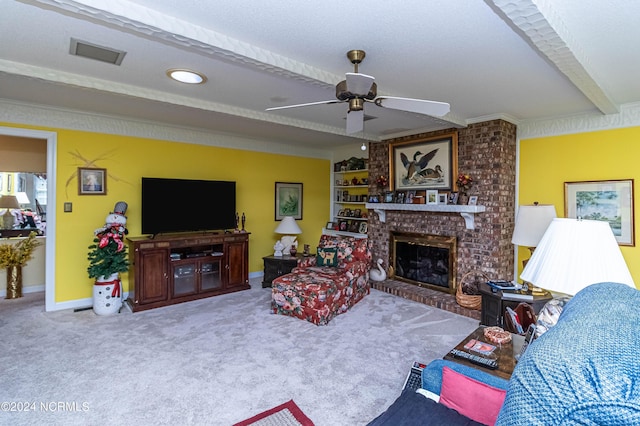 living room with a brick fireplace, beam ceiling, ceiling fan, and carpet flooring