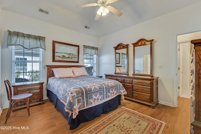 bedroom with multiple windows, light hardwood / wood-style flooring, and ceiling fan