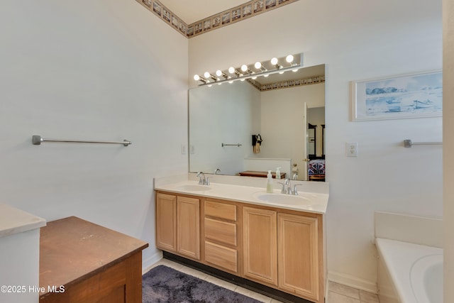 bathroom featuring vanity, tile patterned floors, and a tub to relax in