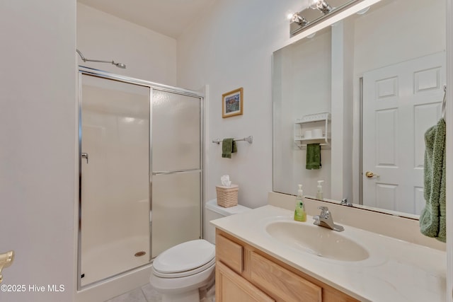 bathroom with vanity, toilet, and an enclosed shower